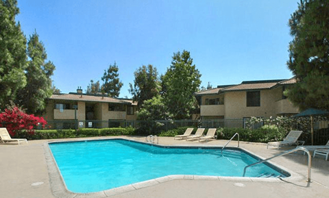 a swimming pool in front of an apartment building